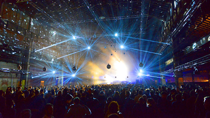 Blue lights twinkle in the building of the Nuit Sonores performance